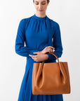 woman tan cognac leather tote bag purse
