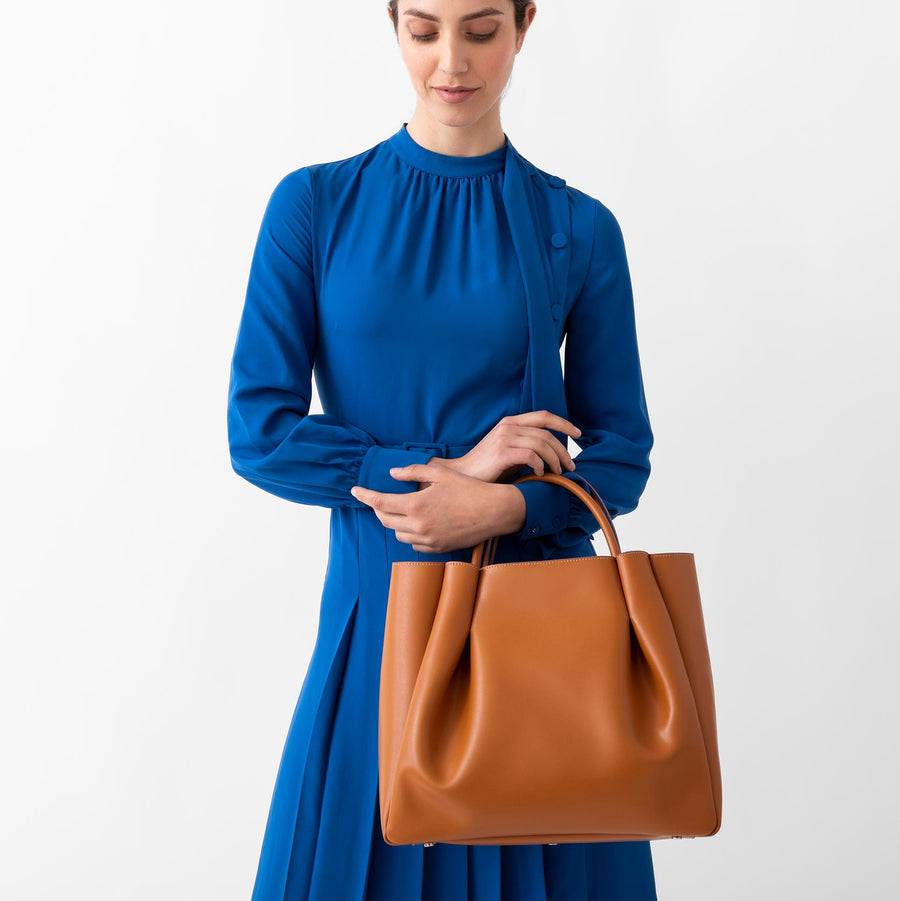 woman tan cognac leather tote bag purse