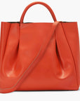large orange leather tote bag purse with shoulder strap