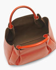 large orange leather tote bag purse with brown interior lining