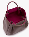 woman with large taupe brown leather tote bag purse with pink interior lining