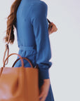 Woman holding large leather tote bag purse