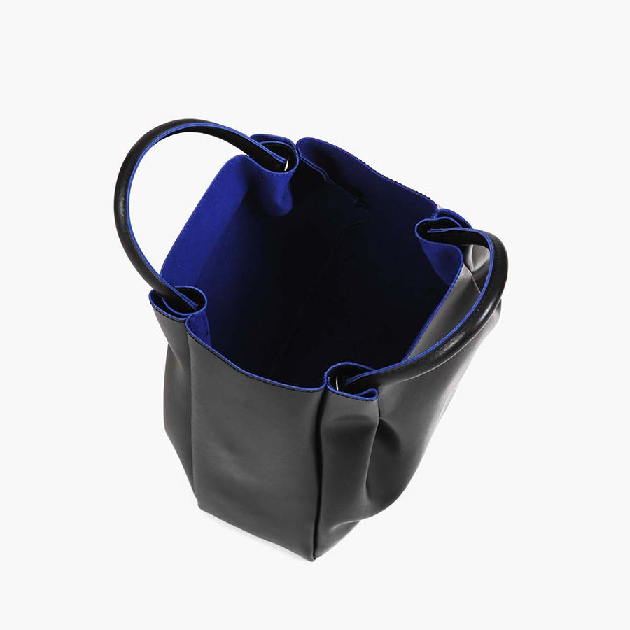 medium black leather tote bag purse with blue interior lining